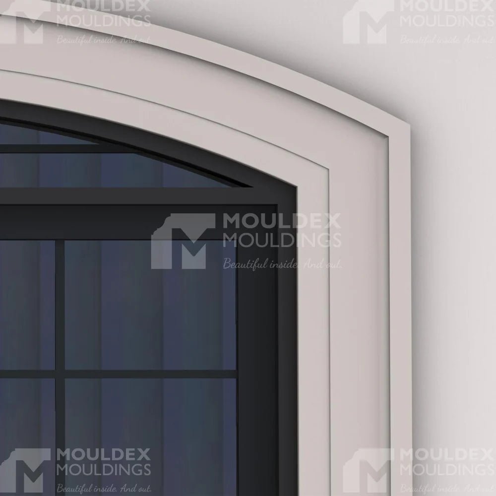 Arched window with composite trim, featuring sharp stepped-edge geometry & a smooth masonry finish for premium exteriors.