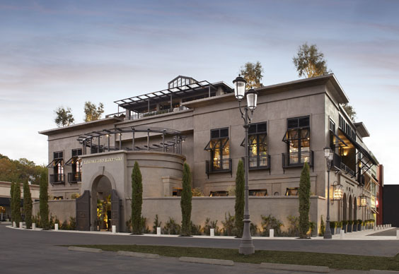 Exterior of a grand Restoration Hardware (RH) architectural gallery featuring classical cement-coated foam mouldings, ornate window headers, and integrated stone facade details.