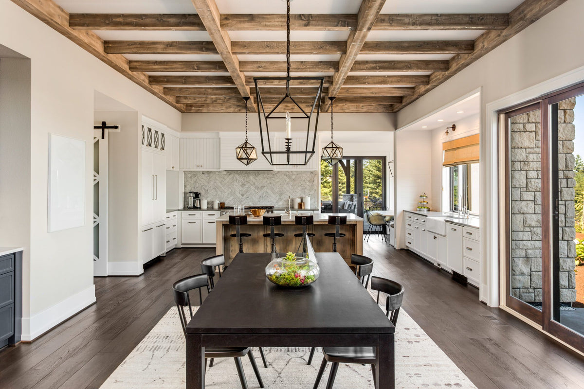 Modern farmhouse kitchen and dining area featuring a high-density polyurethane faux wood beam ceiling system by Mouldex Composites, providing a rustic timber look without the structural weight.