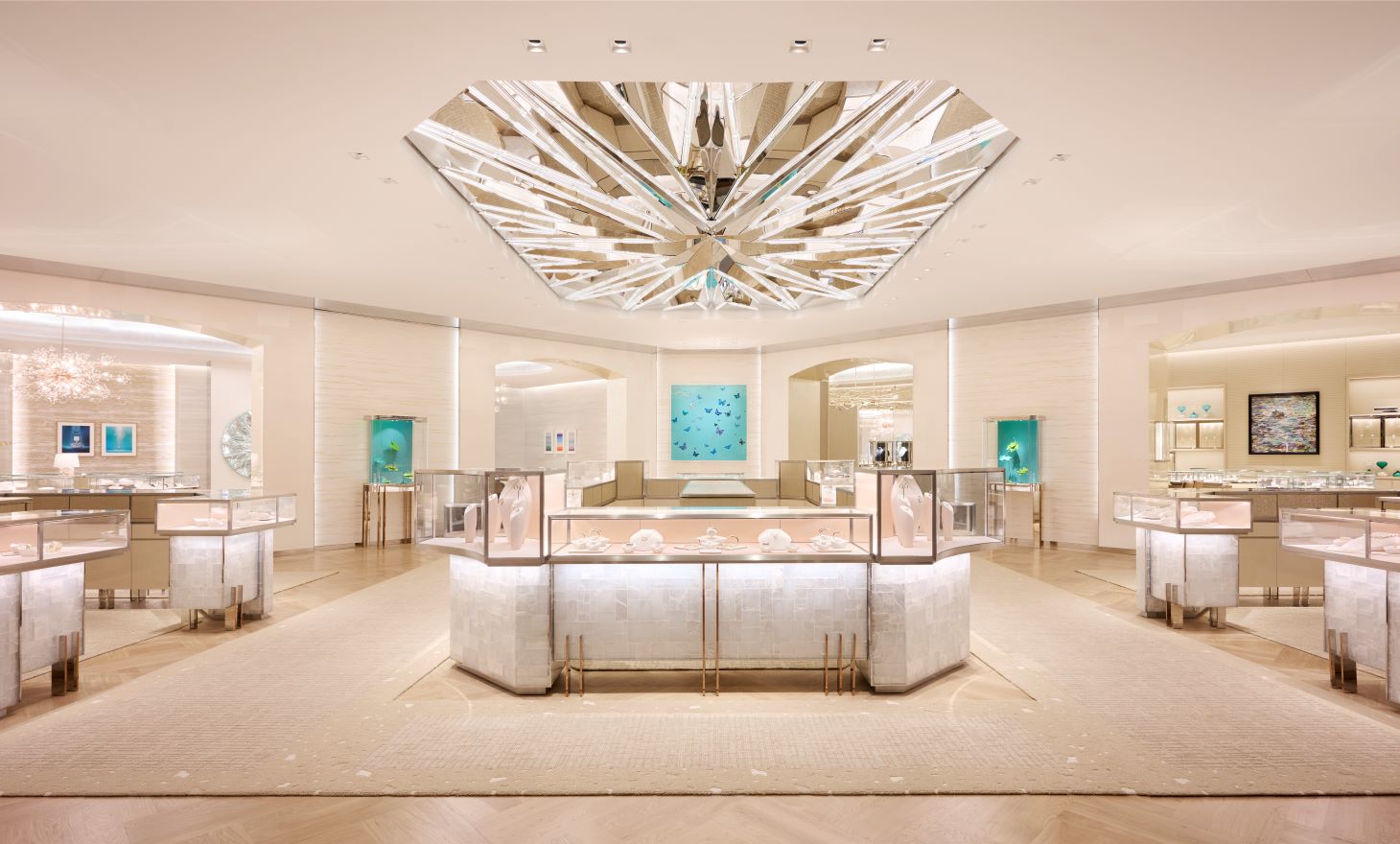 Expansive luxury retail atrium at Tiffany & Co. Yorkdale, featuring a grand hexagonal mirrored ceiling installation, integrated architectural wall mouldings, and custom glass jewelry display islands by Mouldex Composites.